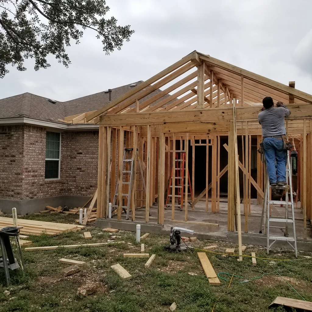 Contractor installing wooden roof framing for a residential home addition project